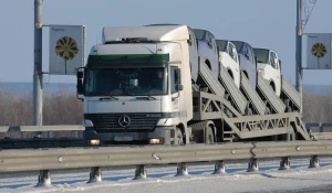 Грузовик везет автомобили.