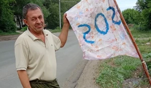 Житель Рубцовска поставил на дороге флаг SOS, чтобы автомобили не «улетали» в яму.