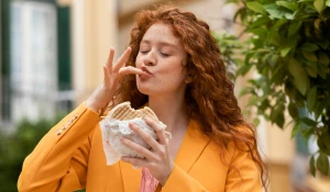 Девушка смакует еду.